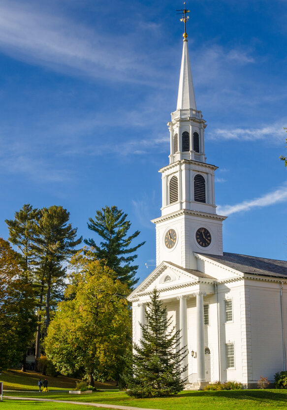 Traditional American White Church with a high Steeple in Williamstown, MA, on a Clear Autumn Day